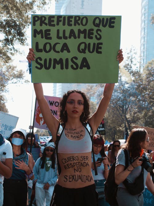 A Woman Holding a Banner at a Demonstration