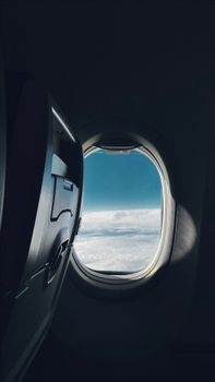 A scenic view of clouds and sky through an airplane window, capturing the essence of air travel.
