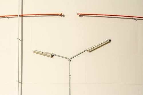 Close-up of a Modern Streetlamp on the Background of a White Wall 