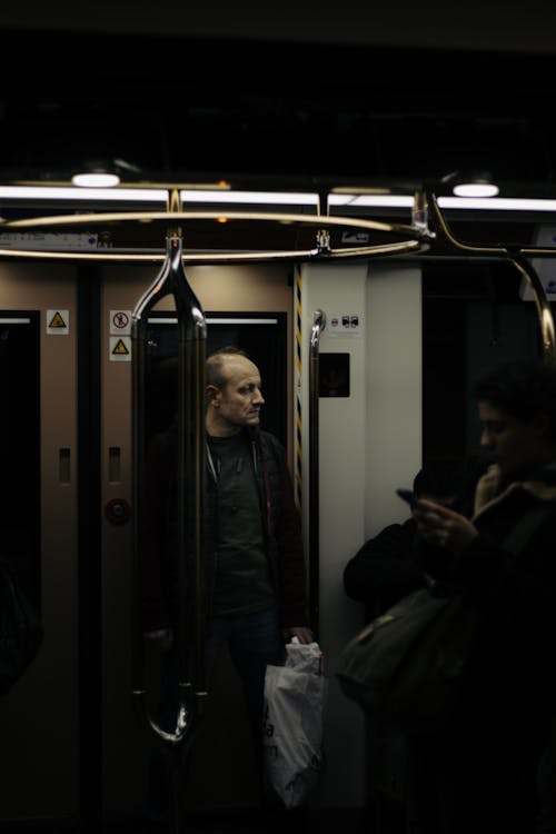 Passengers Standing in a Subway Train 