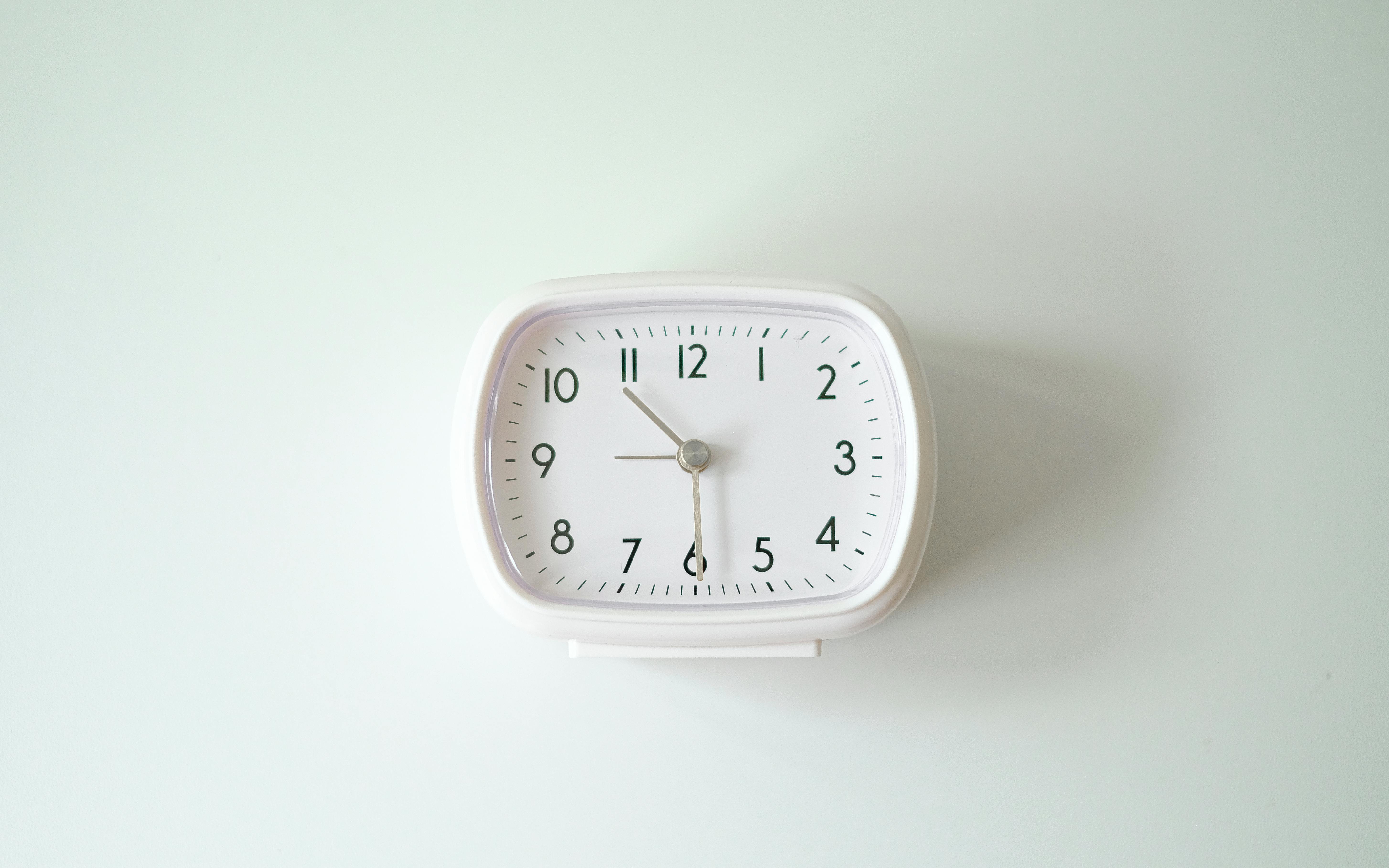 a white clock on a white surface