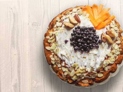 Free Pastry With Nuts Sliced Mangoes and Blackberries on Top Stock Photo