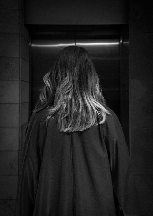Woman Standing in front of Elevator