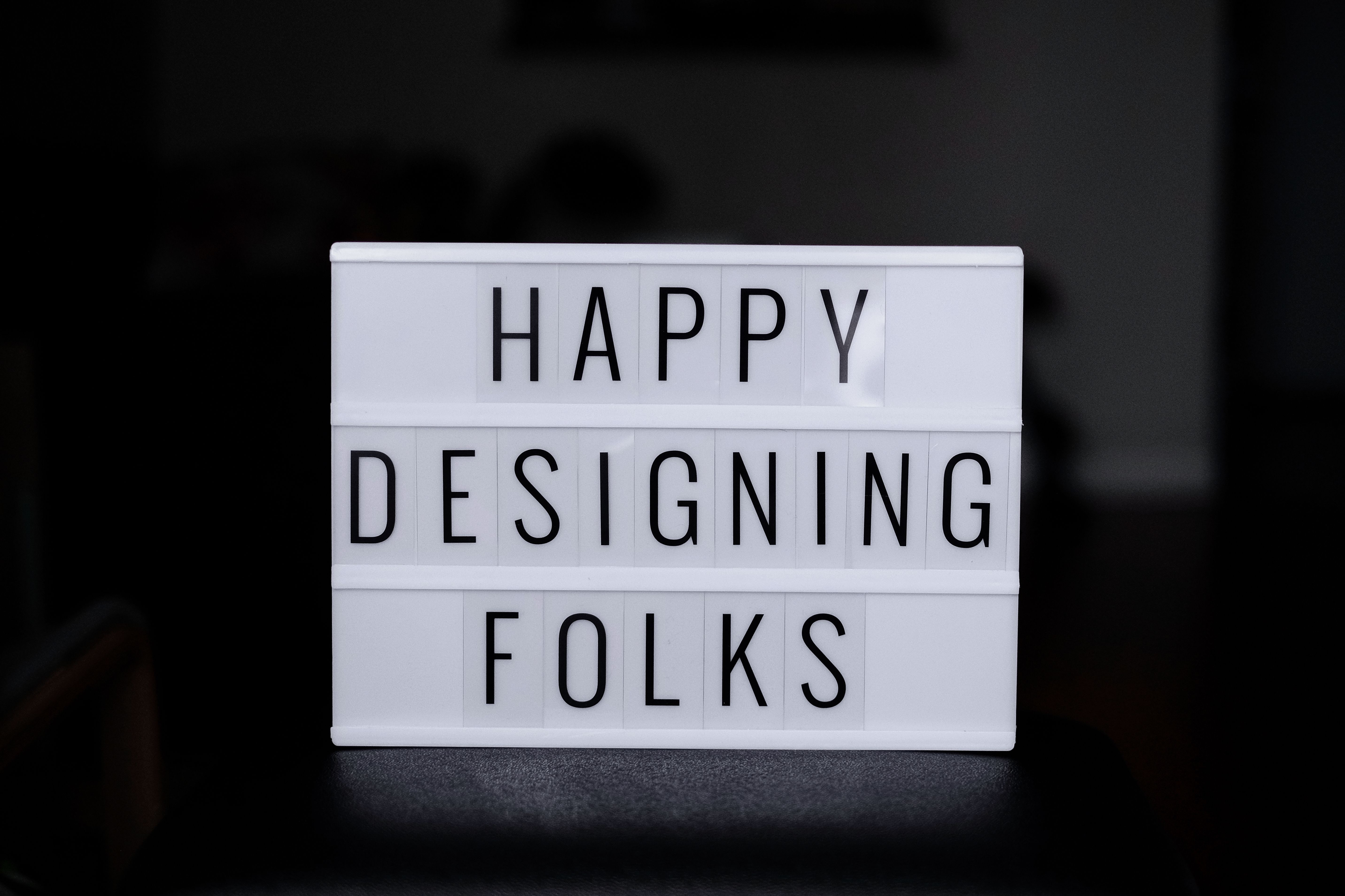 A white light box with the words happy designing folk · Free Stock Photo