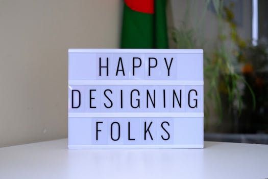 Lightbox saying 'Happy Designing Folks' on a desk, inspiring creativity.
