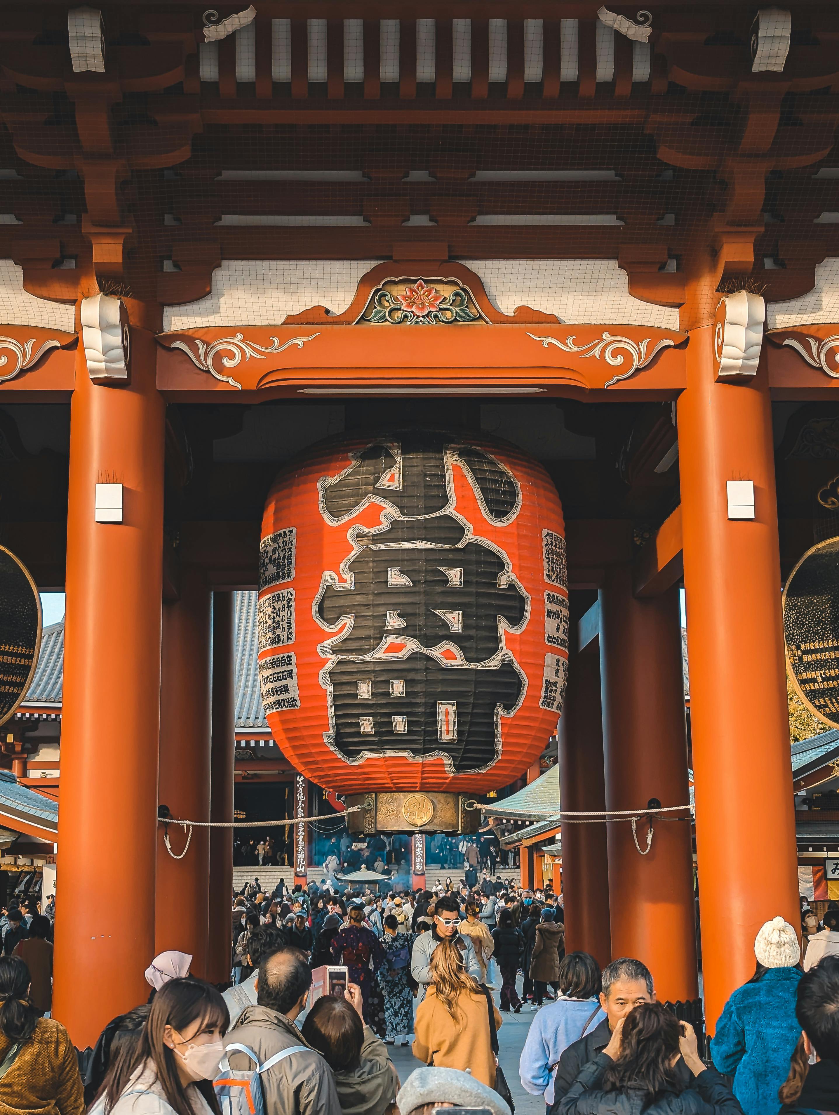 Crowd at Senso-ji Temple entrance, Tokyo. Iconic red lantern symbolizing peace and good fortune.