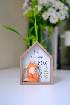 Cozy home decor featuring a clever fox illustration surrounded by chamomile flowers.