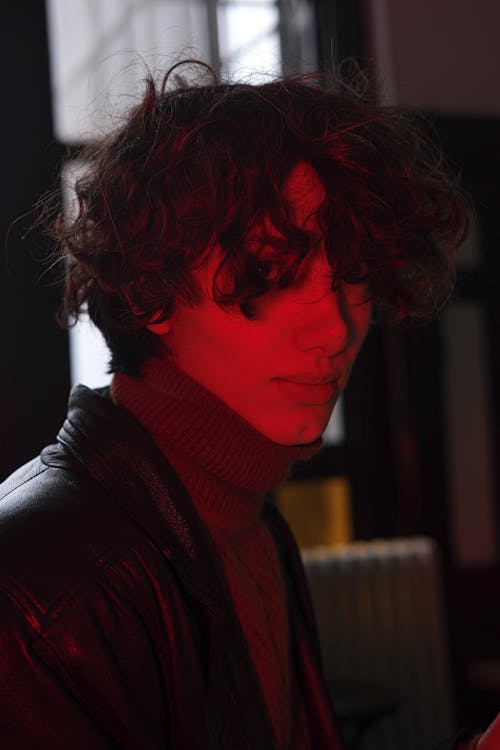 A Man with Curly Hair in Red Light