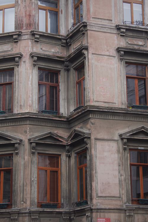 Free A close view of a historic European-style building facade showcasing elegant architectural details. Stock Photo