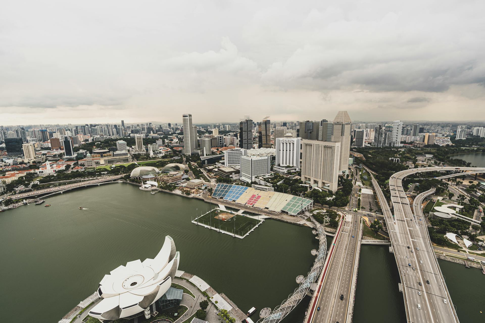 Explore the modern skyline of Singapore with the iconic Marina Bay in an aerial view capturing the city's architecture.