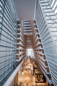 Vertical shot capturing the striking modern design of Marina Bay Sands atrium in Singapore. Perfect for travel or architecture themes.