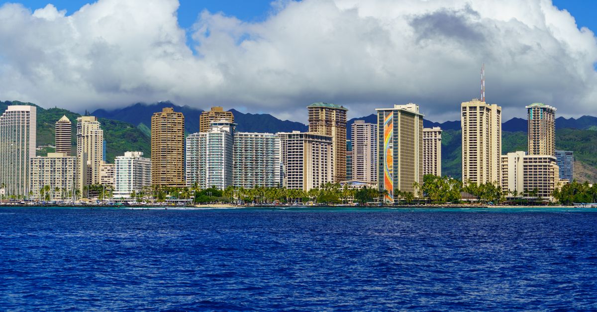 Stunning view of Honolulu's skyline with ocean and mountains in the background.