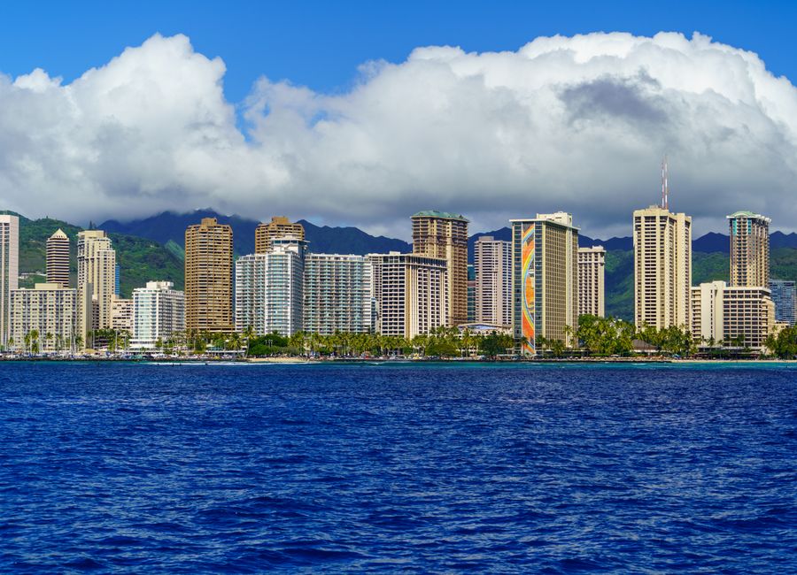 Stunning view of Honolulu's skyline with ocean and mountains in the background.