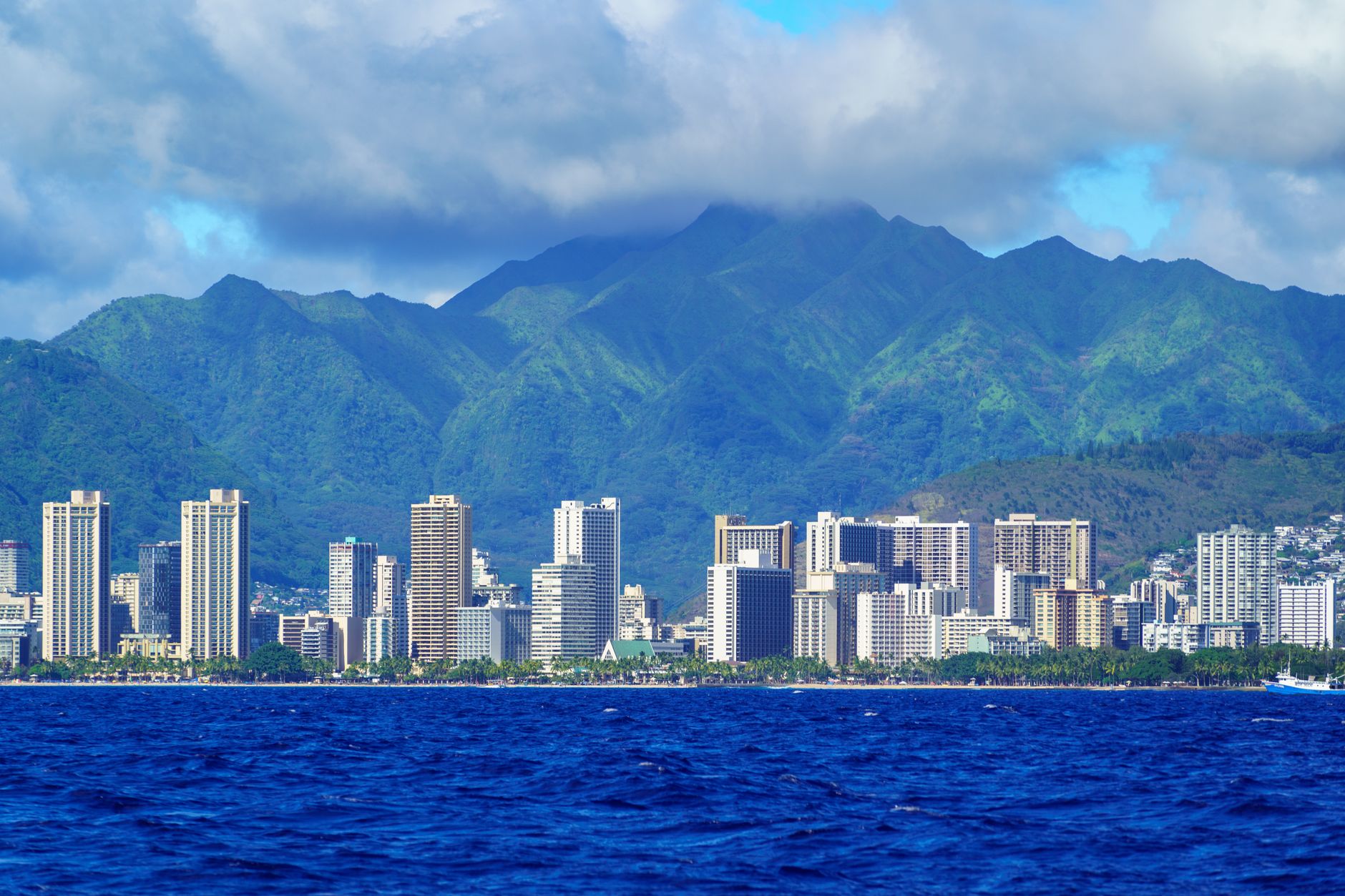 Door hanger delivery in Honolulu, HI Door hanger distribution and flyer delivery in Honolulu, HI — Stunning aerial view of Honolulu's skyline with lush mountains and ocean in foreground. above neighborhoods DoorBlitz crews walk
