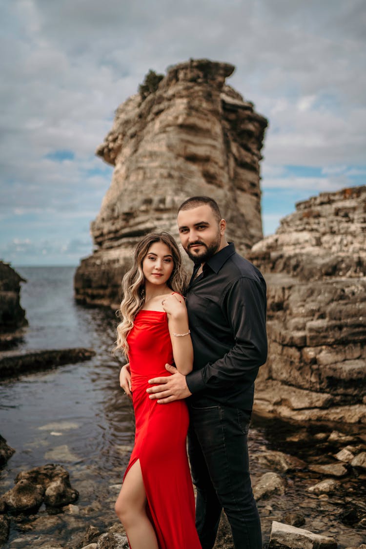 Woman And Man Posing On Sea Shore