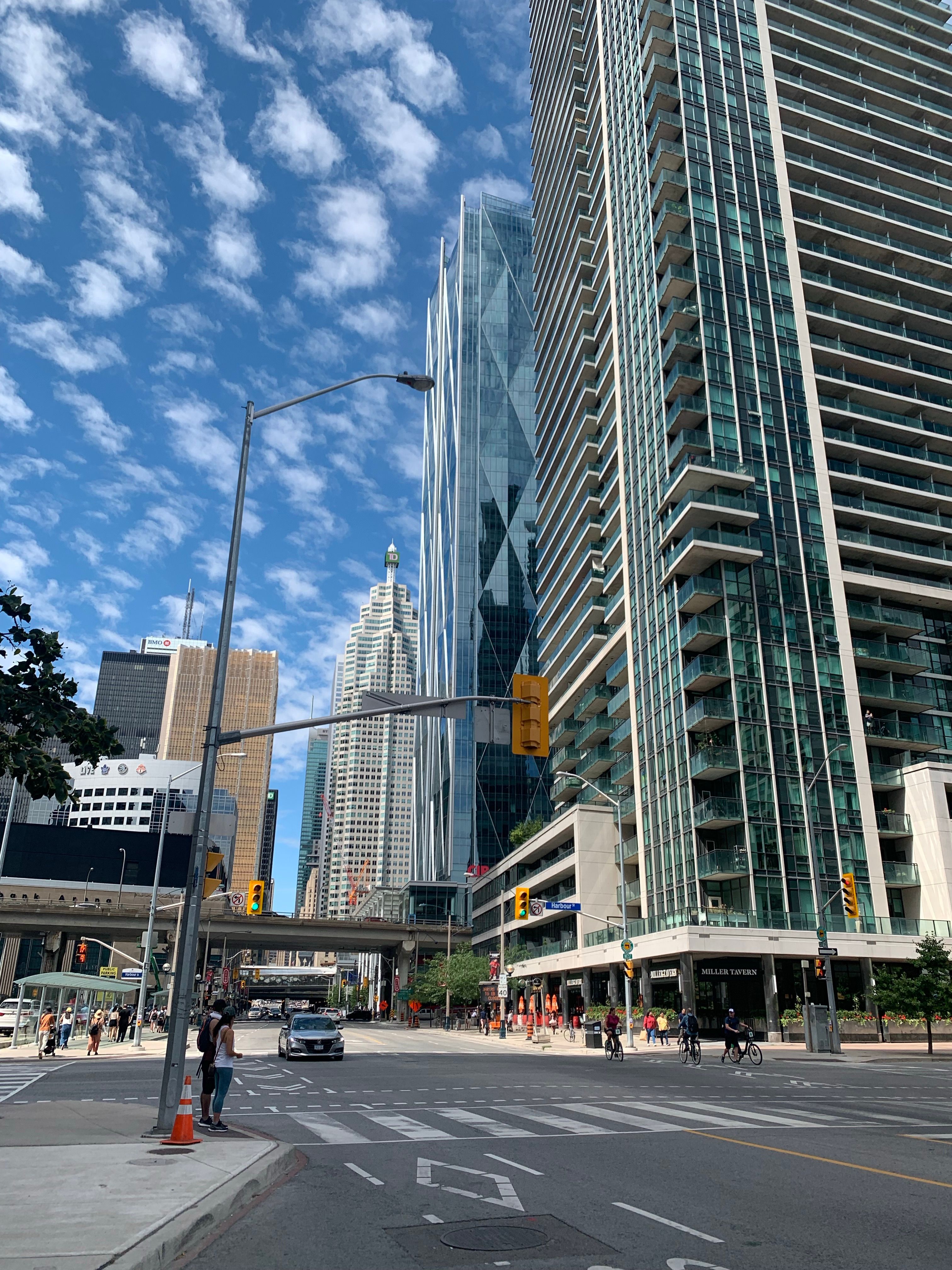 Low Angle View of Glass Skyscraper on City Street · Free Stock Photo