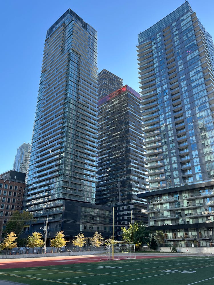 Football Field Under Glass Skyscrapers