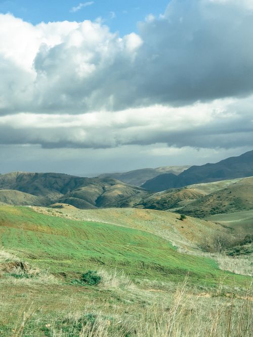 Free Beautiful mountain landscape under dramatic clouds in Oran, Algeria perfect for travel or nature visuals. Stock Photo