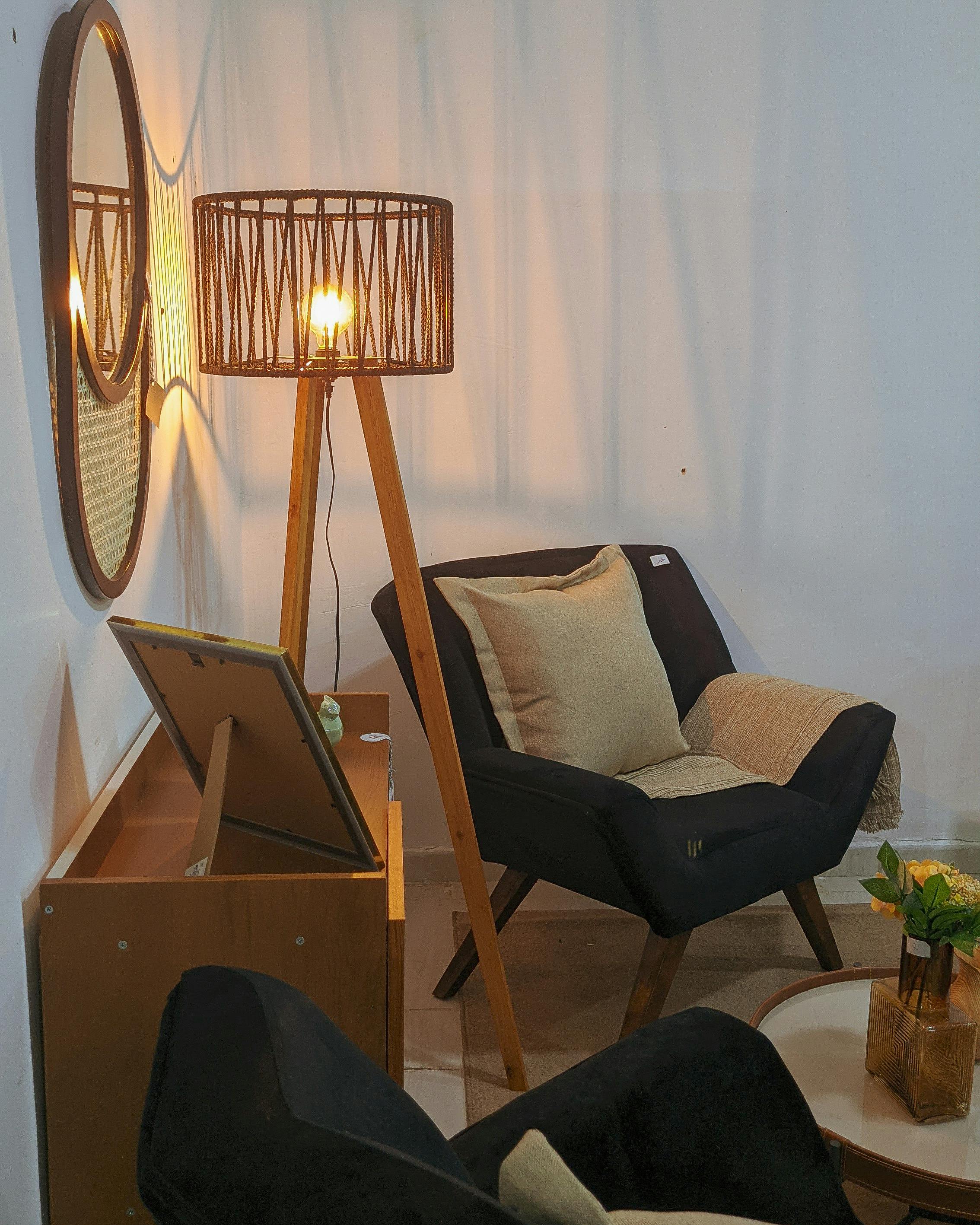 Vintage-style living room with armchair, tripod lamp, and decor elements.