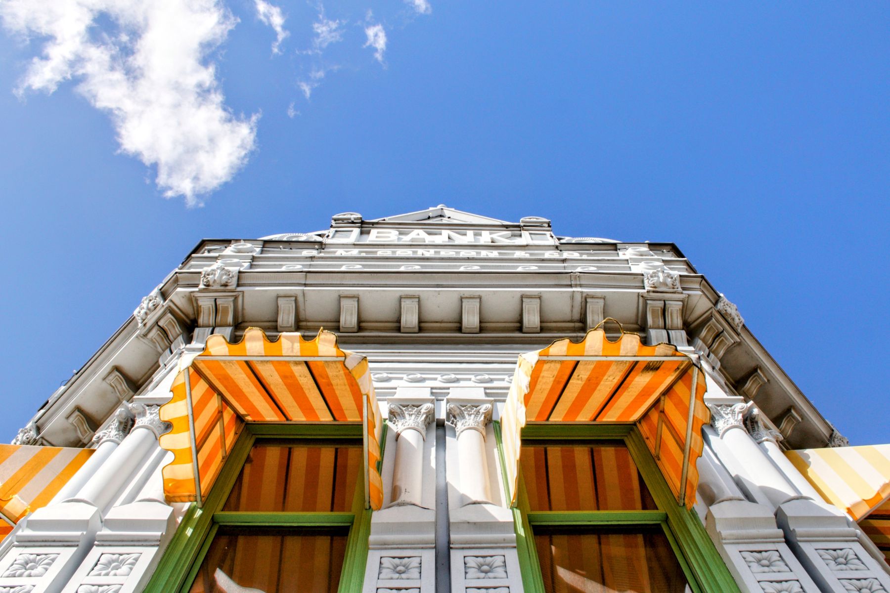 Historic building facade beneath a blue sky.
