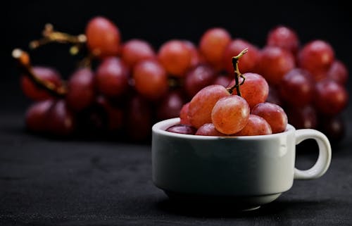 Free Mighty Red Grape in Black Background. (Ate it right away after the photograph) Stock Photo