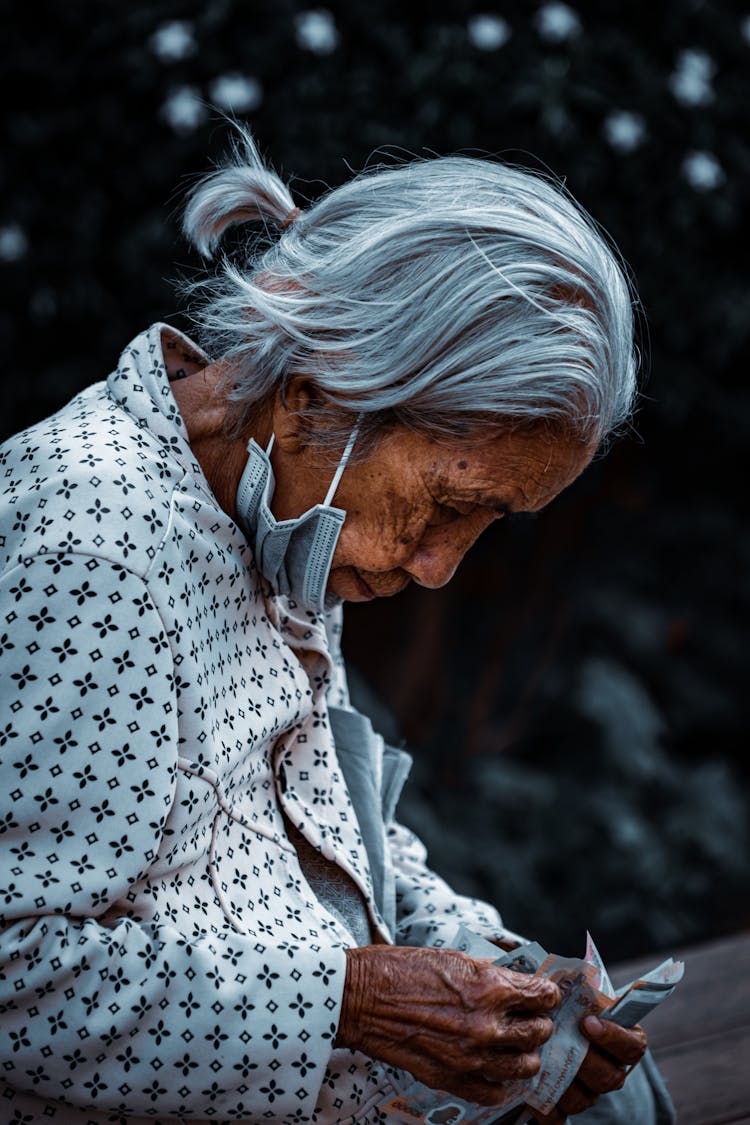 Elderly Woman Holding The Money 