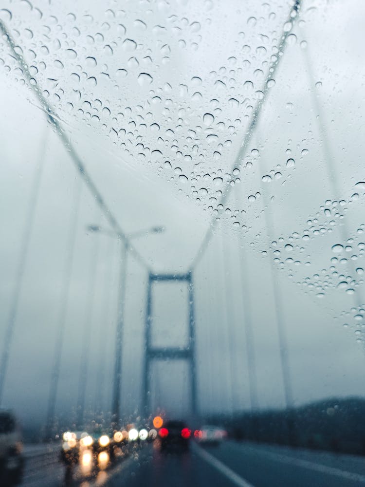 Cars On Bridge Behind Wet Car Window