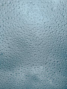 Detailed view of raindrops on window glass, capturing a rainy day in Istanbul, Türkiye.