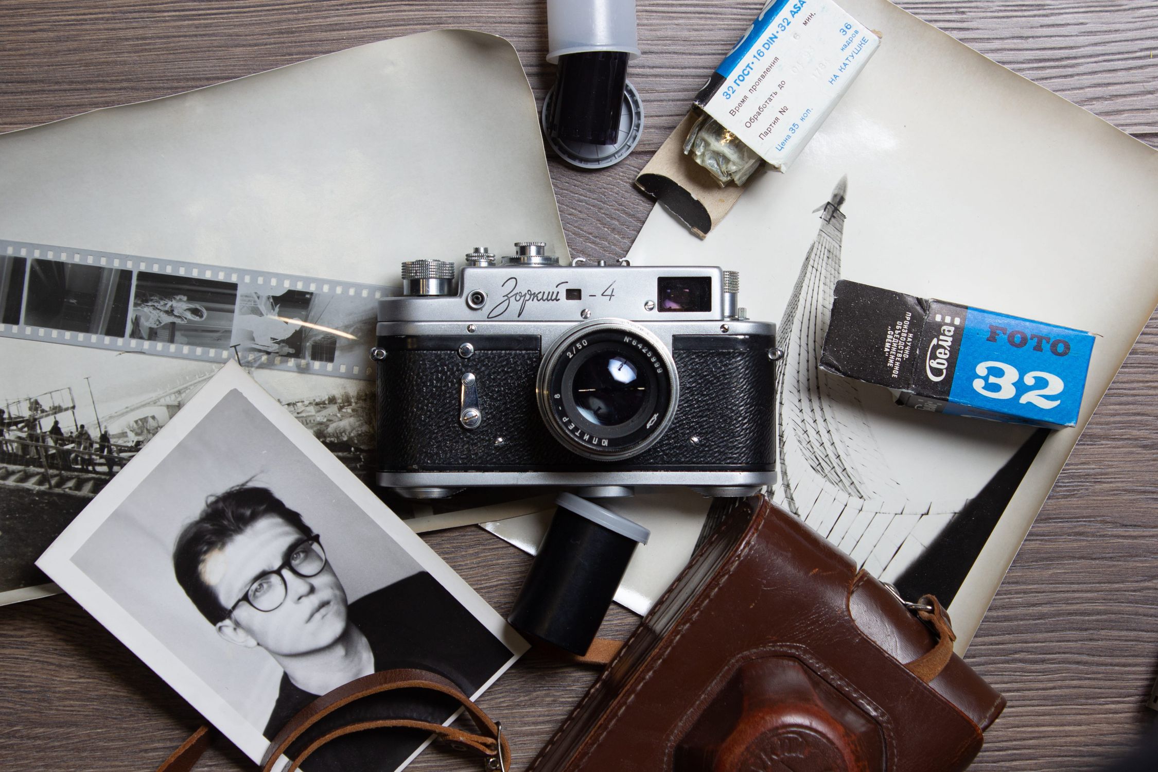 Shell Camera Roll Retro Camera and Film Rolls on Desk · Free Stock Photo