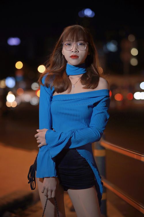 Free Elegant woman in blue blouse posing on city street at night. Stock Photo