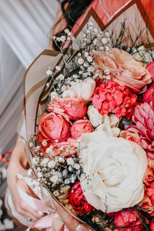 Free Close-up of an elegant floral bouquet featuring pink and white roses with delicate accents. Stock Photo