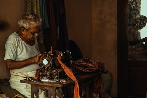 Man Sewing on a Vintage Machine 