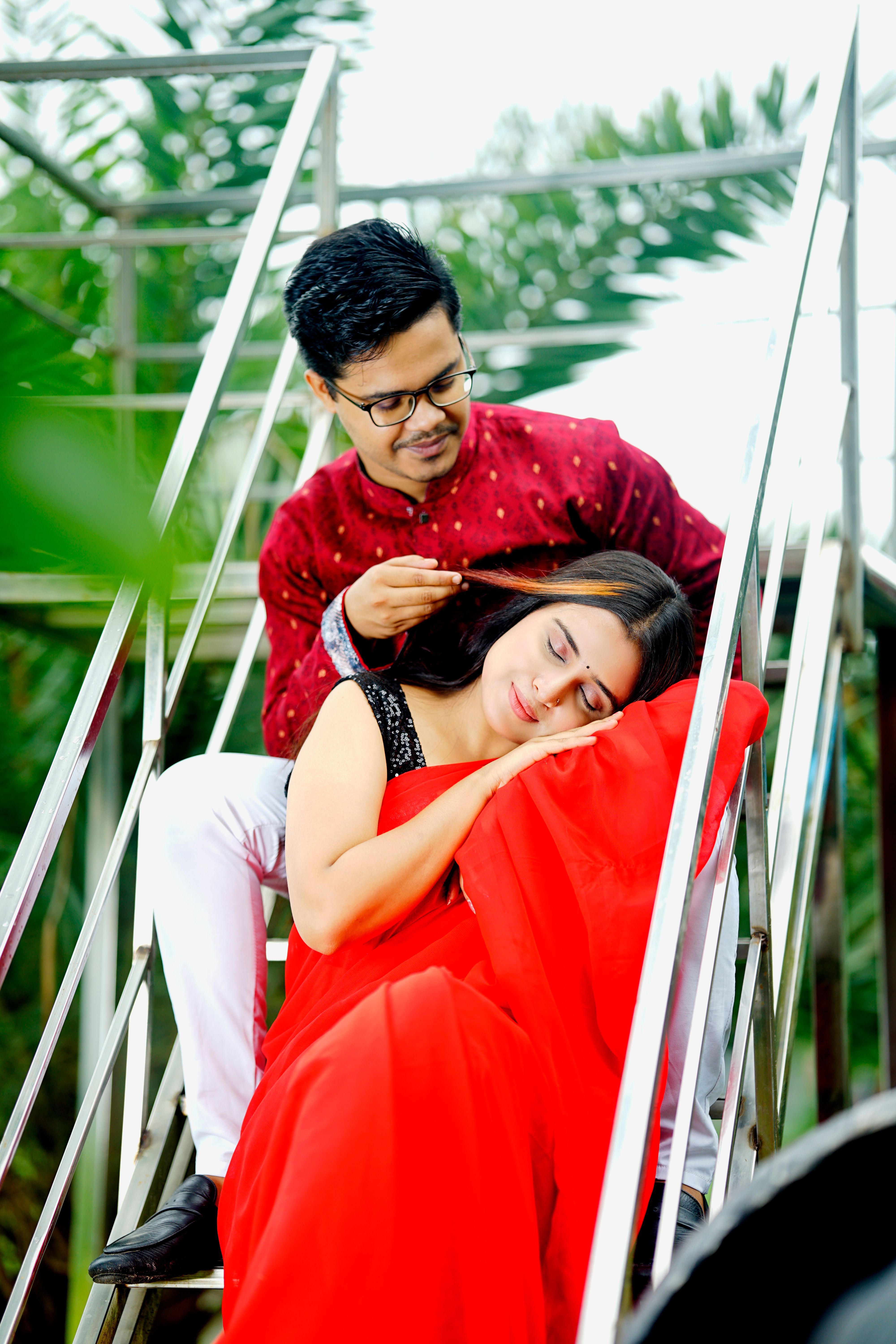 Young Couple in Traditional Clothing Sitting on Steps · Free Stock Photo