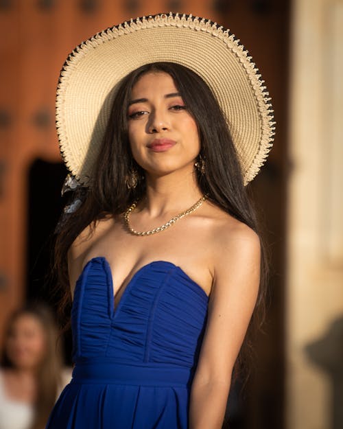 A Brunette in a Hat and Blue Dress