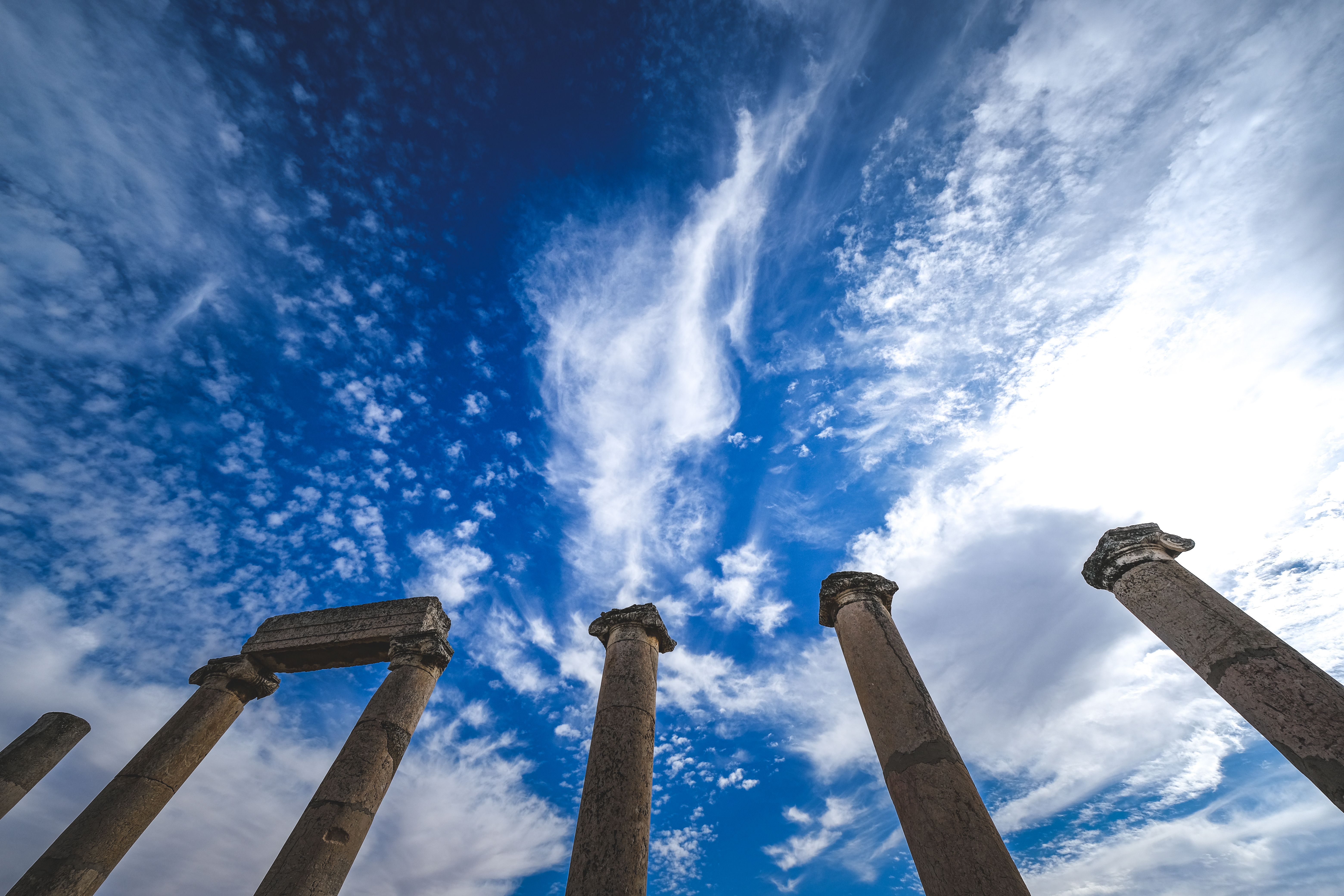 Ancient Columns under White Clouds in Blue Sky · Free Stock Photo