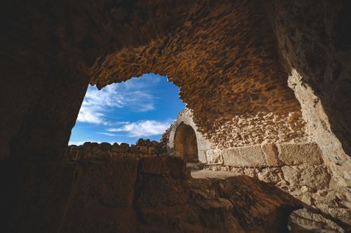 Free Explore ancient stone ruins against a vibrant blue sky, showcasing historic architecture and natural beauty. Stock Photo