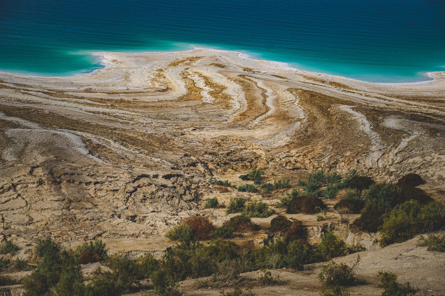A breathtaking aerial shot of the unique Dead Sea coastline with striking geological formations.