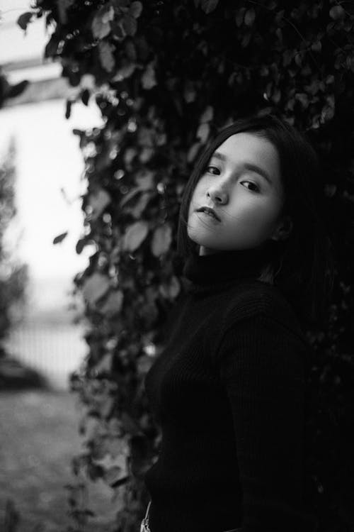 Black and White Photo of a Girl Wearing a Sweater 