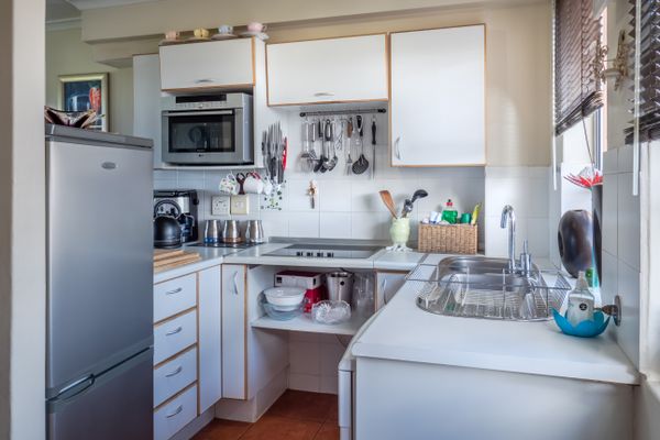 Clean refinished white kitchen cabinets