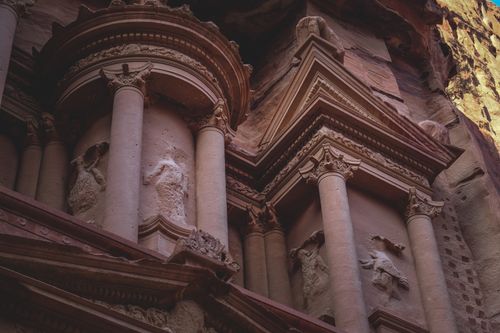 Free Detailed view of the ornate columns and carvings of Petra's ancient architecture at dusk. Stock Photo