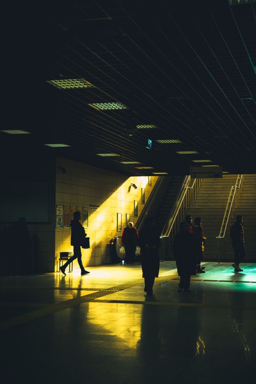 Free Dark corridor in Istanbul subway with silhouetted figures and dramatic lighting. Stock Photo