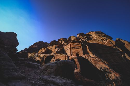 Free Explore the ancient sandstone carvings of Petra, a UNESCO World Heritage Site in Jordan, at dusk. Stock Photo