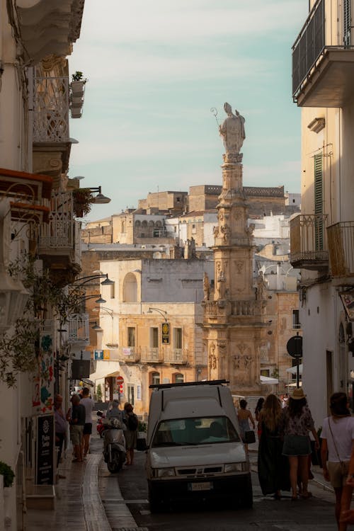 Free Narrow Street Leading to the Statue of Saint Orontius of Lecce on Ostuni Square Stock Photo