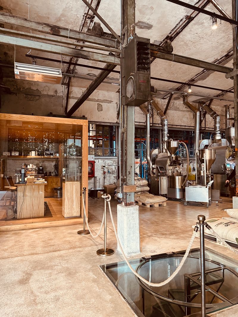 Industrial production facility with machinery and overhead pipes