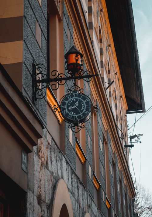 Free Vertical shot of a vintage clock on a building facade in Sarajevo, Bosnia and Herzegovina, with metalwork details. Stock Photo
