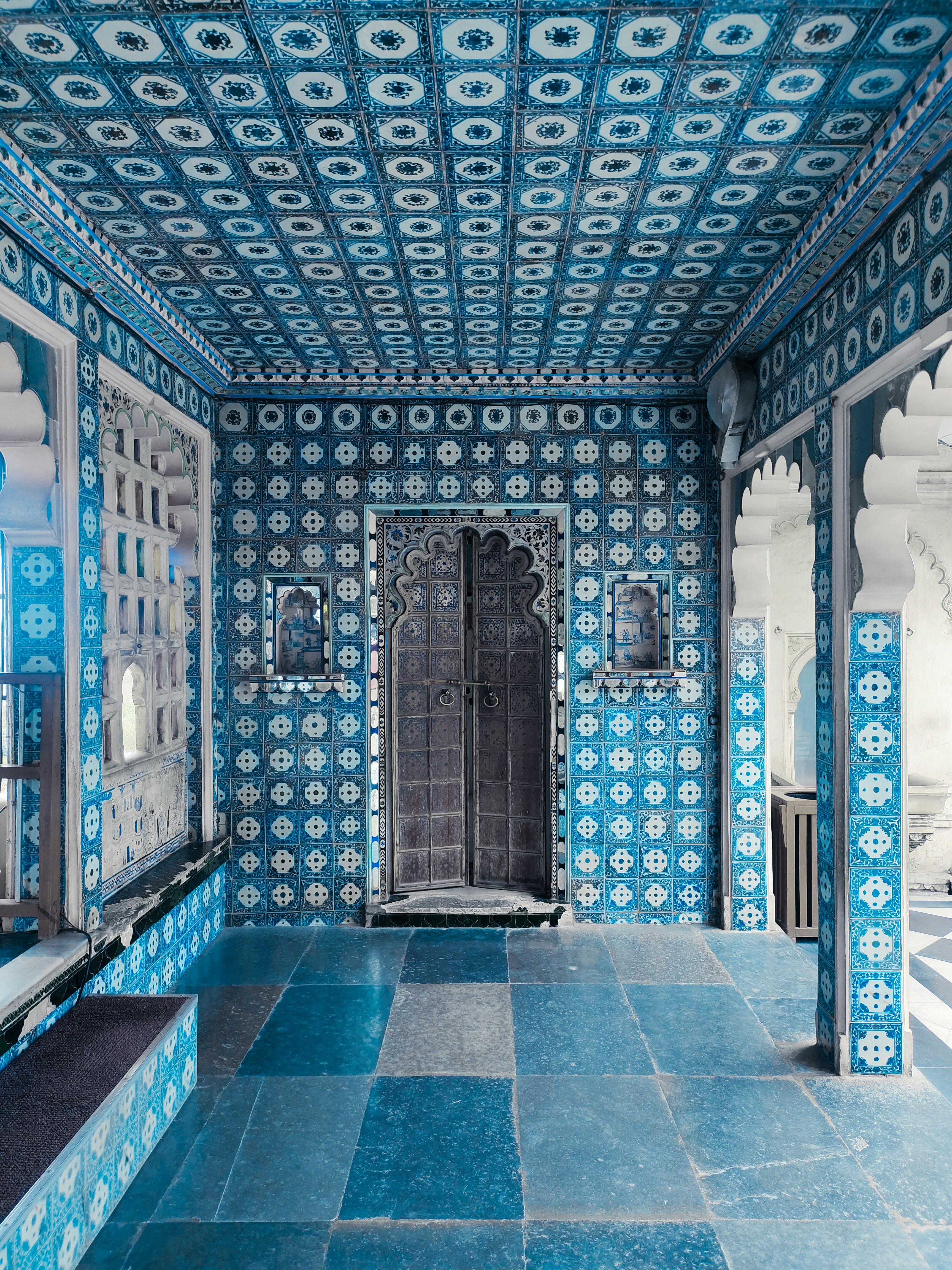 Captivating blue-tiled room showcasing ornate Mughal architecture in India.