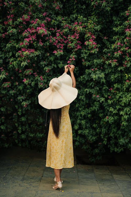 Woman by Flowering Shrub