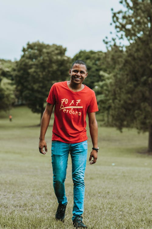 Photo of Man Walking Grass Field