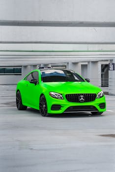 Bright green Mercedes sports car parked in a modern urban parking garage, showcasing luxury and style.