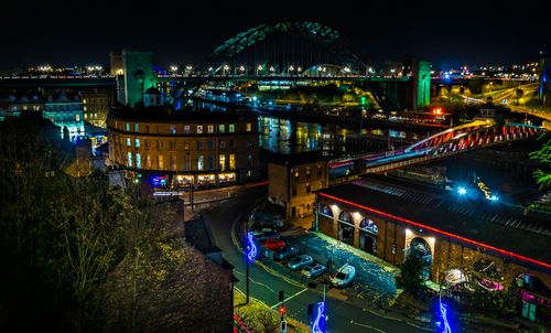 Free Aerial view of Newcastle Quayside at night with illuminated bridges and cityscape lights. Stock Photo